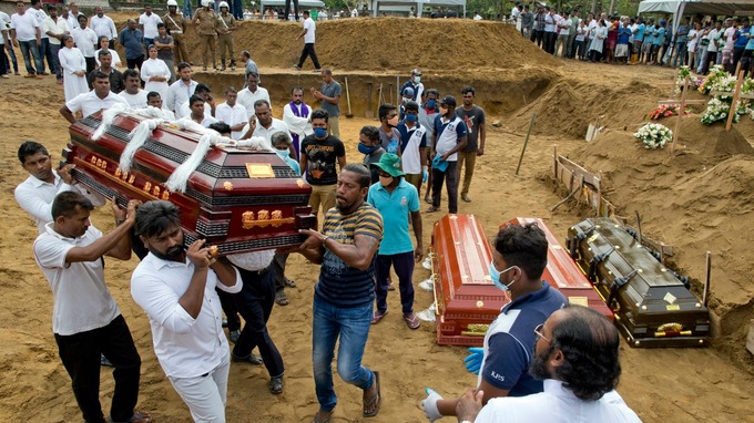 Relatives carry a coffin for burial during a mass burial for Easter Sunday bomb blast victims in Negombo, Sri Lanka.